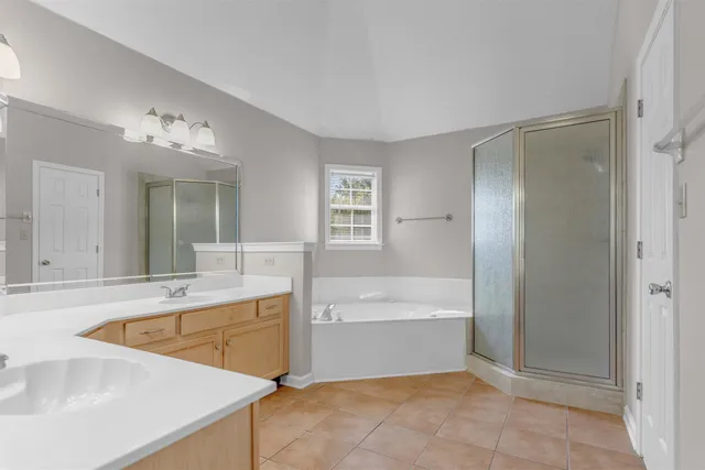 a bathroom with a tub sink and mirror