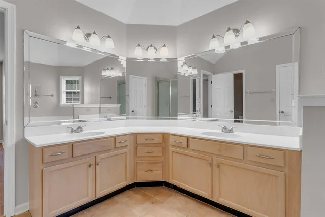 a bathroom with a sink vanity and a mirror