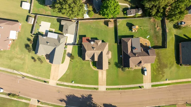 an aerial view of a house with a swimming pool