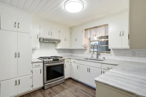a kitchen with a stove oven and sink