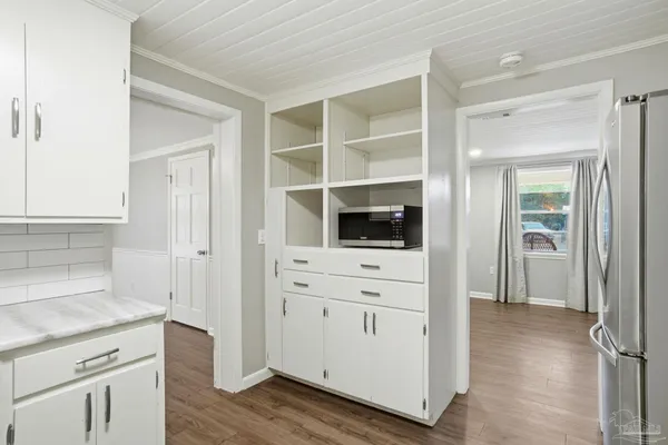 a hallway with cabinets and wooden floor