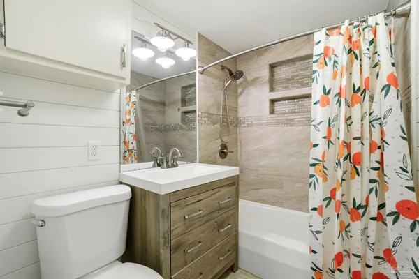 a bathroom with a sink toilet and shower