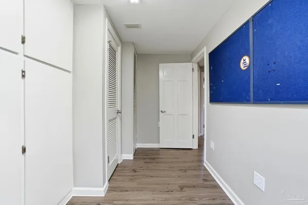 a view of a hallway with wooden floor