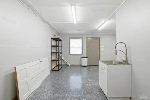 a view of an empty room with window and fireplace