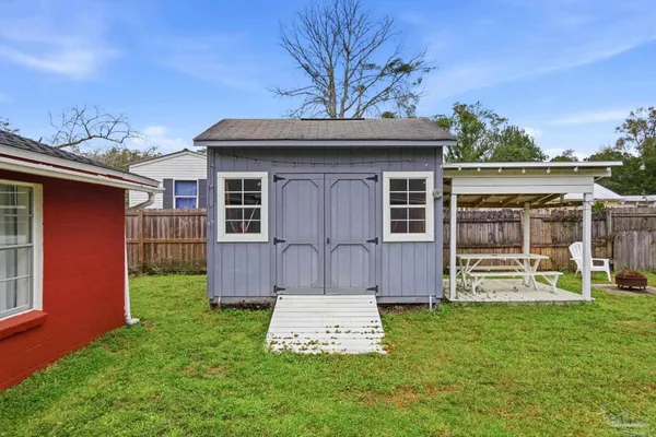 a front view of a house with garden and sitting area