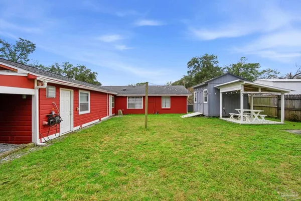 a view of a backyard with a garden and trees