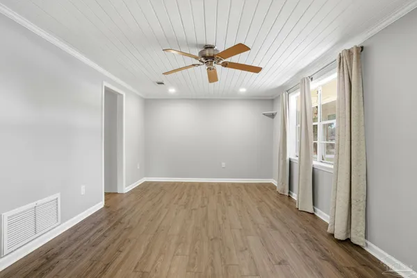 wooden floor in an empty room with a window