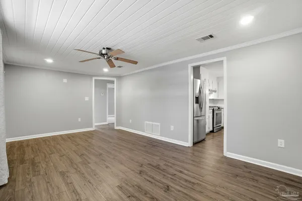 wooden floor in an empty room with a window