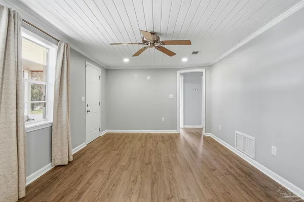 wooden floor in an empty room with a window