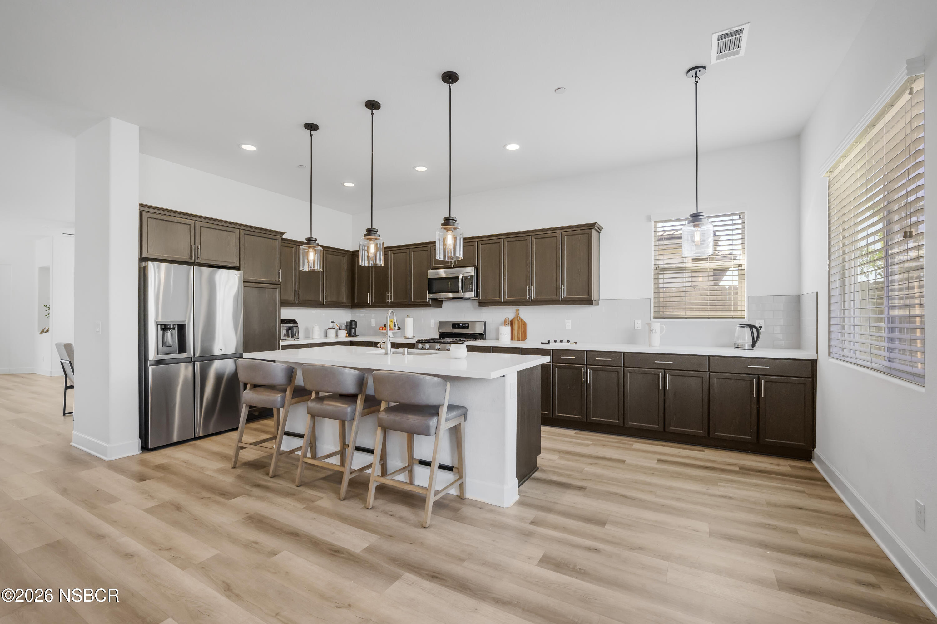 751 Skyview Lane Santa Maria, CA 93455 - Photo 8 of 31 a kitchen with stainless steel appliances kitchen island granite countertop a sink refrigerator and cabinets