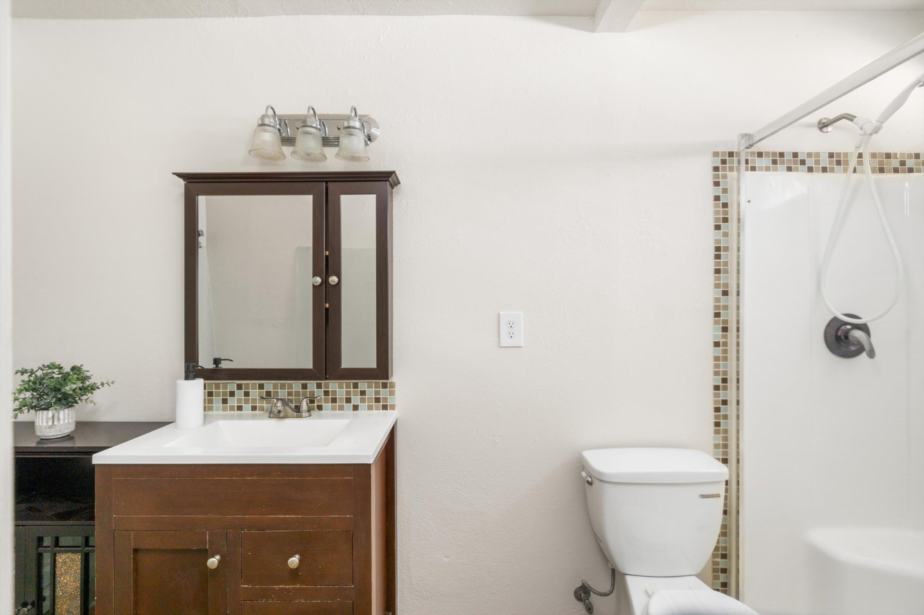 3316 Rucker Road Lompoc, CA 93436 - Photo 14 of 24 a bathroom with a granite countertop sink a toilet and a mirror