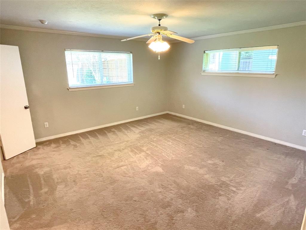 4847 Twin Post Road Dallas, TX 75244 - Photo 11 of 36 Primary bedroom with crown molding and ceiling fan