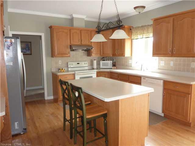 515 Higgins Road Cheshire, CT 06410 - Photo 1 of 1 a kitchen with stainless steel appliances granite countertop a stove a refrigerator a sink dishwasher and a dining table with wooden cabinet