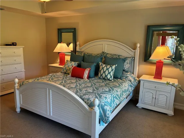 a bedroom with a bed and dresser