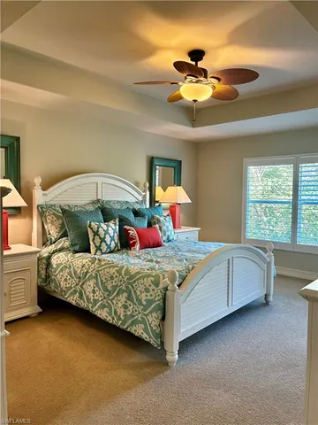 a bed room with a bed and a chandelier