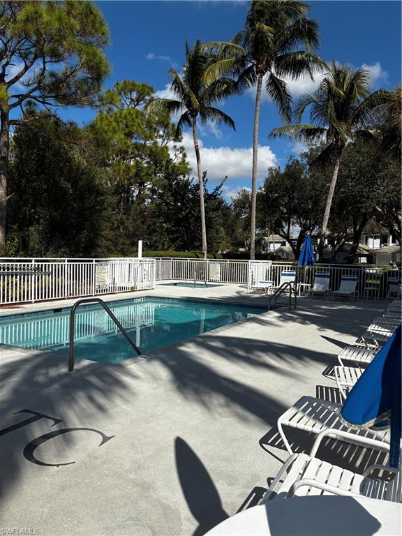 913 Carrick Bend Circle, Unit 202 Naples, FL 34110 - Photo 28 of 44 a view of a patio with swimming pool