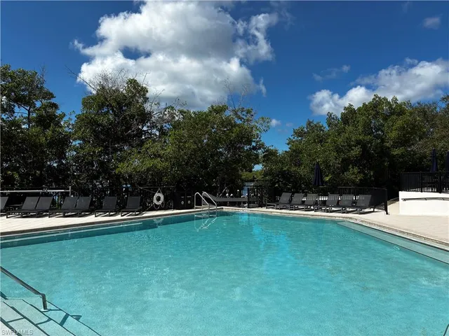 a view of a swimming pool with a yard