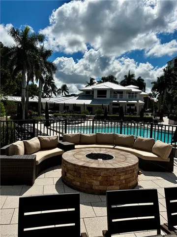 a view of a patio with couches chairs and a fire pit