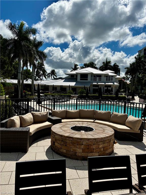 913 Carrick Bend Circle, Unit 202 Naples, FL 34110 - Photo 34 of 44 a view of a patio with couches chairs and a fire pit