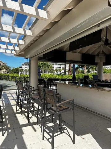 a view of a patio with table and chairs potted plants