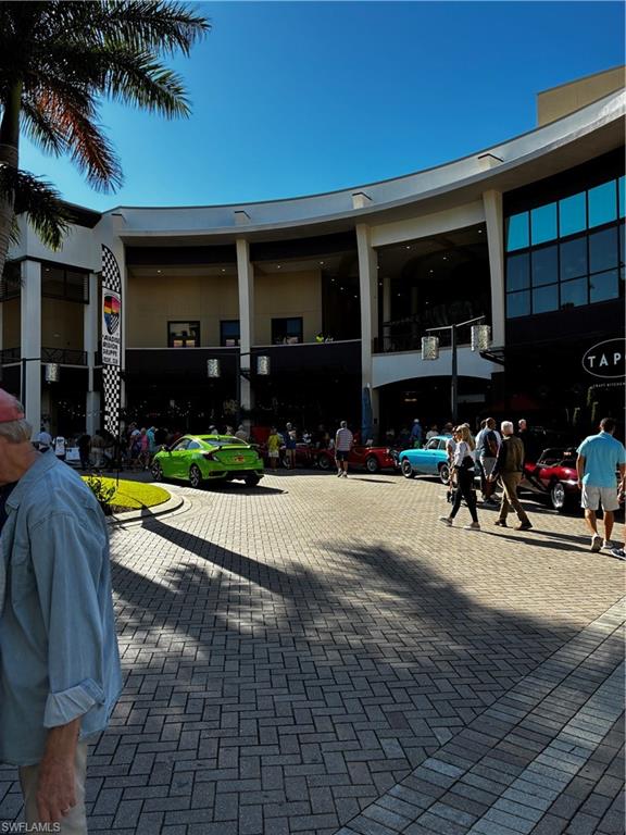 913 Carrick Bend Circle, Unit 202 Naples, FL 34110 - Photo 40 of 44 a view of a house with sitting area and garden