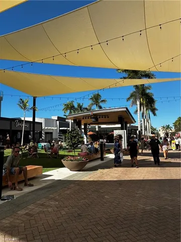 a front view of residential houses with yard and tree