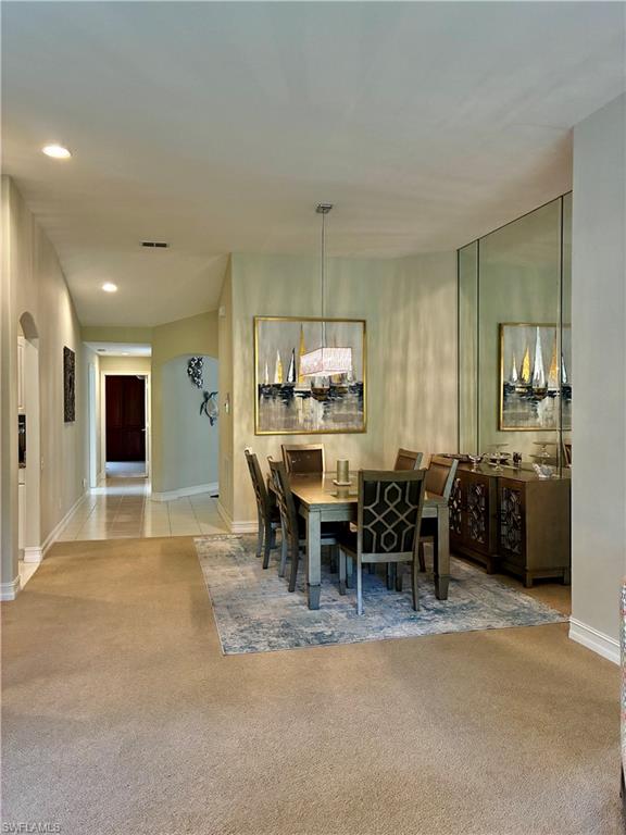 913 Carrick Bend Circle, Unit 202 Naples, FL 34110 - Photo 7 of 44 a dining room with furniture and a kitchen view
