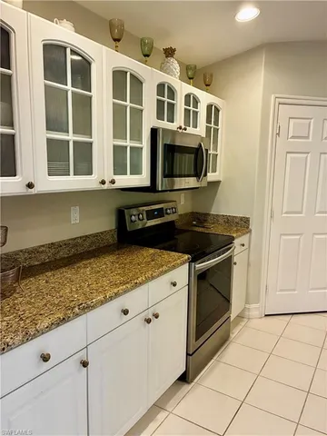 a kitchen with stainless steel appliances granite countertop a stove and a microwave