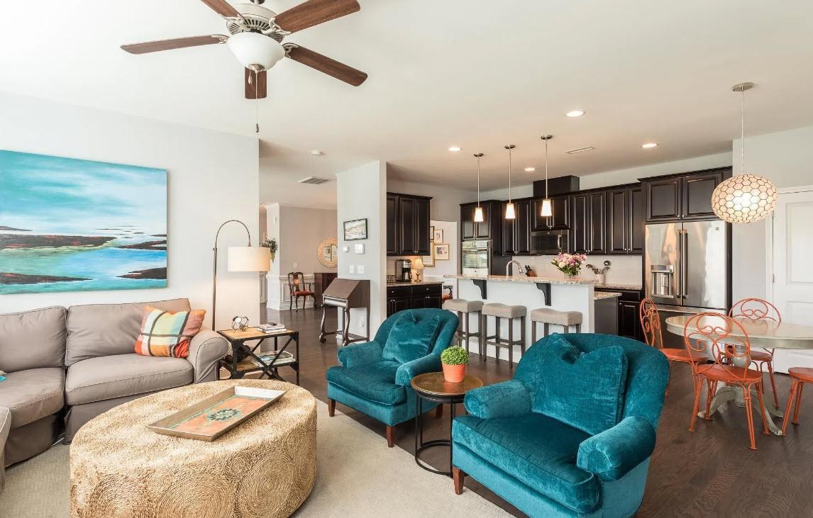 114 Willow View Lane Apex, NC 27539 - Photo 11 of 34 a living room with furniture kitchen view and a chandelier