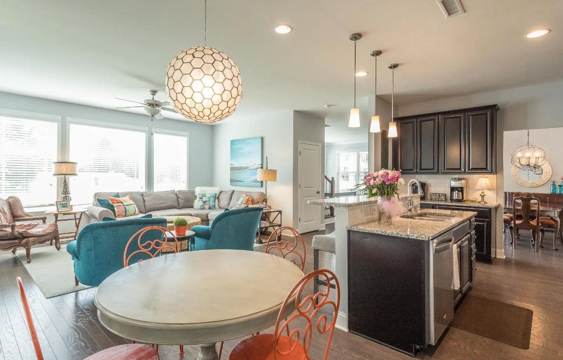 114 Willow View Lane Apex, NC 27539 - Photo 15 of 34 a very nice looking open dining room with kitchen island granite countertop a table chairs and a chandelier