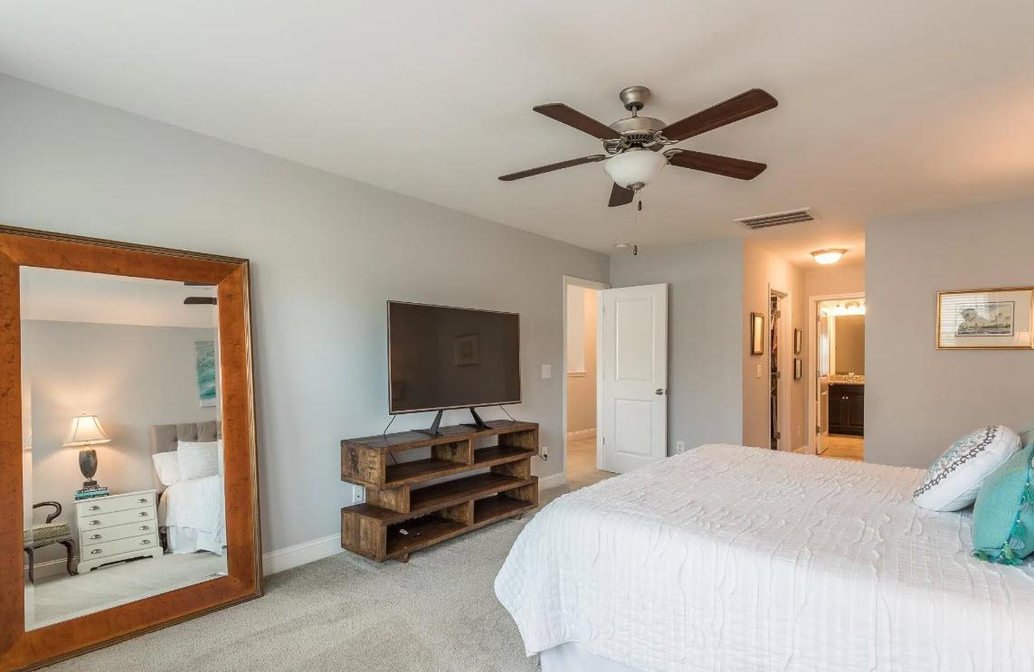 114 Willow View Lane Apex, NC 27539 - Photo 19 of 34 a bedroom with bed and a chandelier