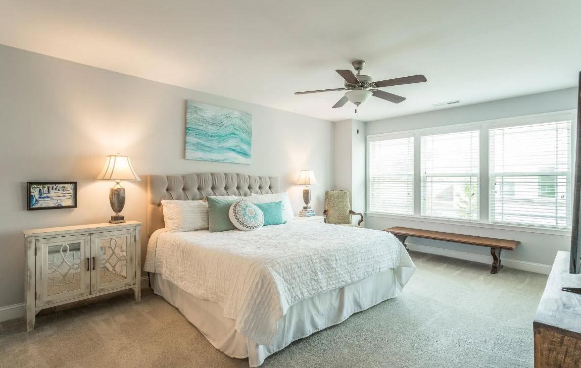 114 Willow View Lane Apex, NC 27539 - Photo 20 of 34 a bedroom with bed and a chandelier