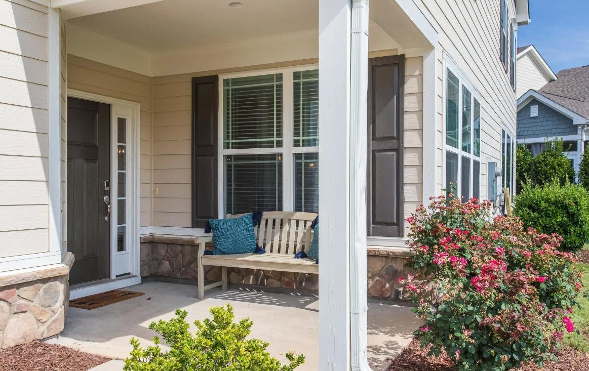 114 Willow View Lane Apex, NC 27539 - Photo 3 of 34 a garden with a bench in front of house