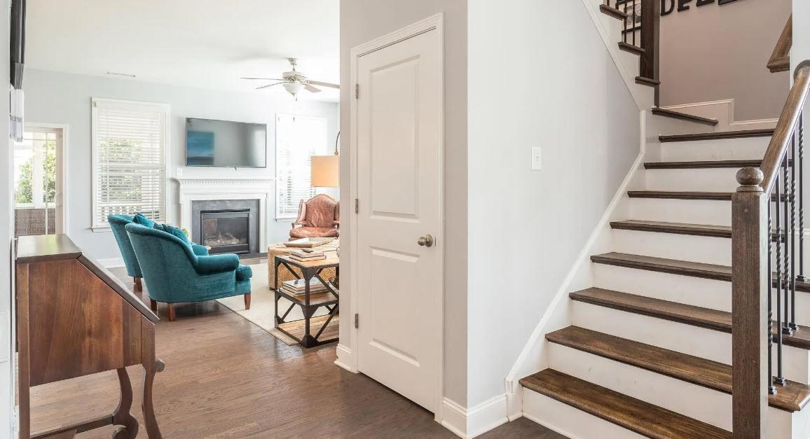 114 Willow View Lane Apex, NC 27539 - Photo 4 of 34 a living room with furniture a fireplace and a floor to ceiling window