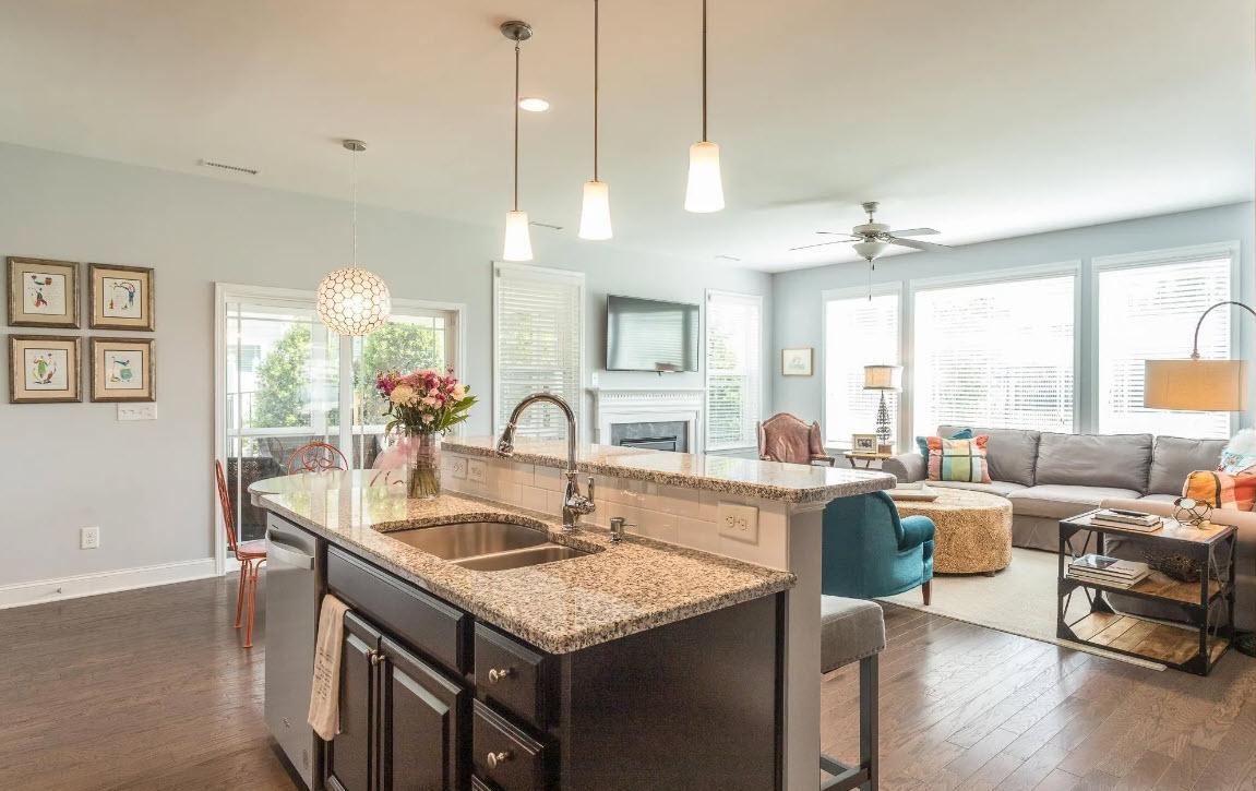 114 Willow View Lane Apex, NC 27539 - Photo 9 of 34 a open kitchen with stainless steel appliances granite countertop a sink a stove and chairs with wooden floor
