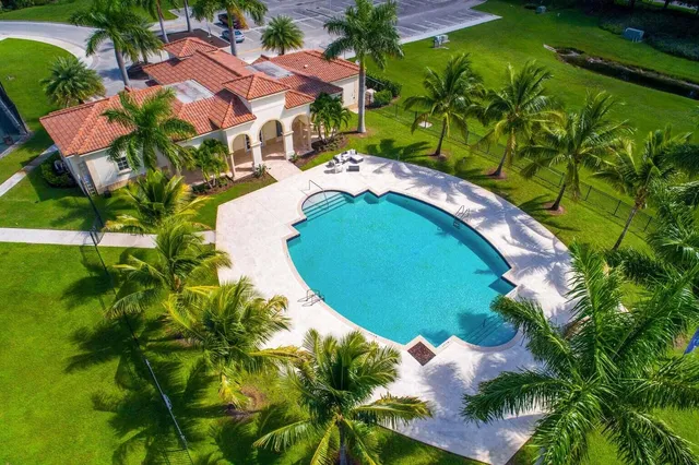 an aerial view of a house with a yard and outdoor seating