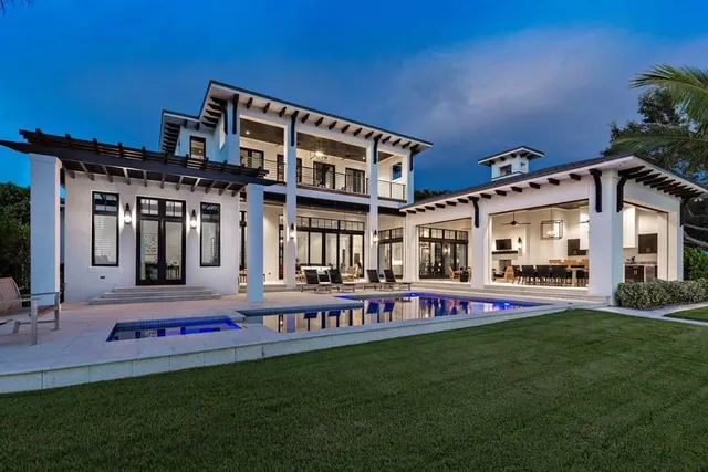 a front view of building with yard and outdoor seating