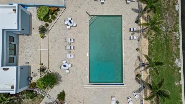 an aerial view of a house with a garden and swimming pool