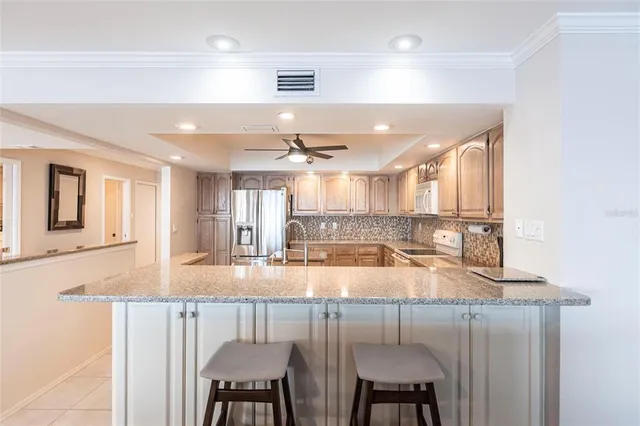 a kitchen with a refrigerator sink and cabinets