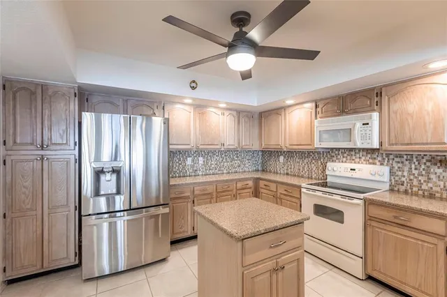 a kitchen with a sink cabinets stainless steel appliances and a window