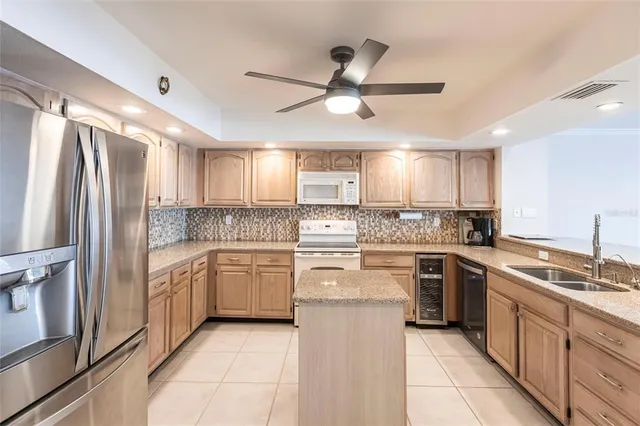 a kitchen with a stove sink and cabinets