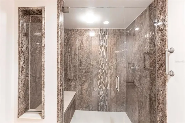 an empty room with wooden floor and entrance door