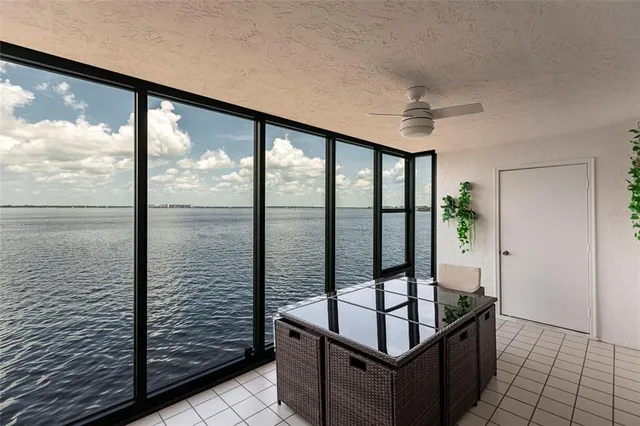 a living room with furniture a flat screen tv and a large window