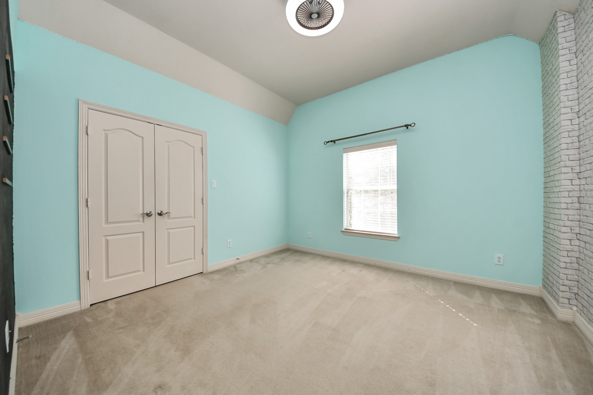 17618 Raven Canyon Lane Houston, TX 77095 - Photo 32 of 45 Bright and airy bedroom with unique brick accent walls and natural light, perfect for creative spaces.