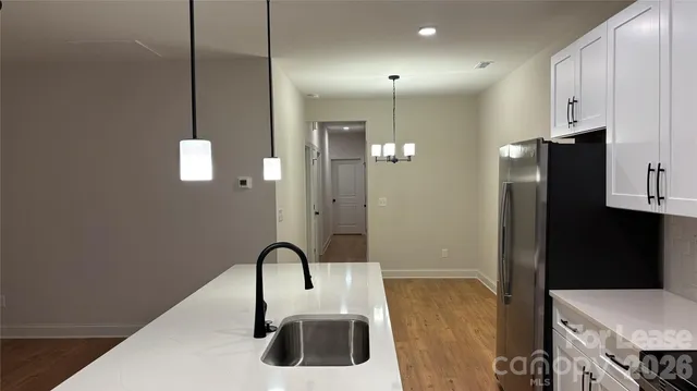 a kitchen with a sink and chandelier