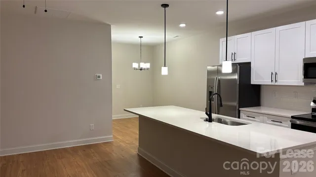 a kitchen with a sink a refrigerator and a stove