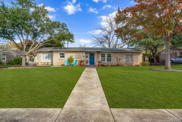 a view of house that has a yard