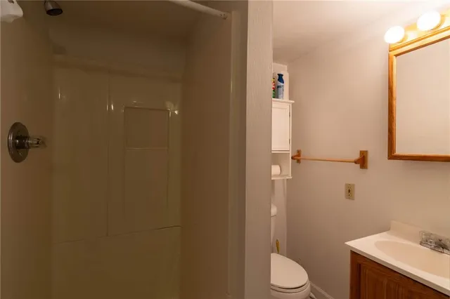a white toilet sitting next to a bathroom sink