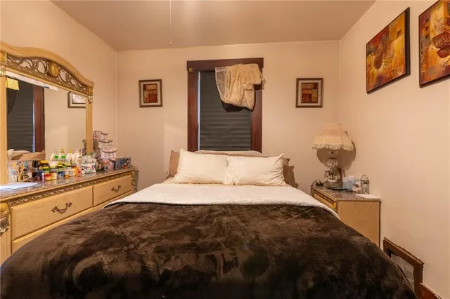 a bedroom with a bed and a mirror