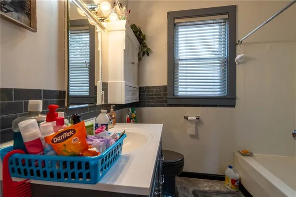 a dining room with furniture and a window